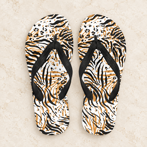 Animal-pattern flip-flops with black straps on pale stone.