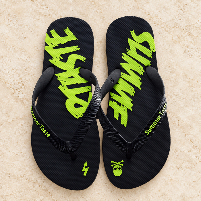Black and lime flip-flops with graphic footbeds on ivory stone.