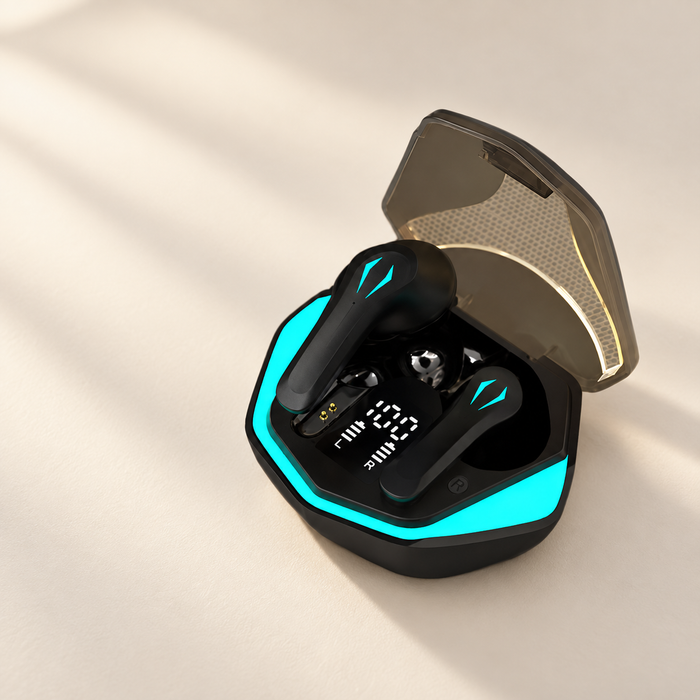 Black and cyan earbuds in open charging case on ivory surface