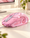 Pink wired gaming mouse on an ivory desk.