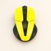 Yellow and black wireless mouse on warm ivory surface