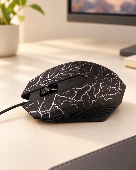 Dark wired mouse with a pale branching pattern on an ivory desk.