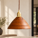 Brown wooden pendant lamp with a brass socket in an ivory dining room.