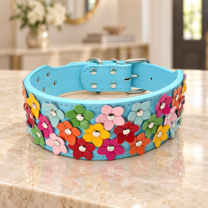 Turquoise collar with multicoloured flower appliques on an ivory console.