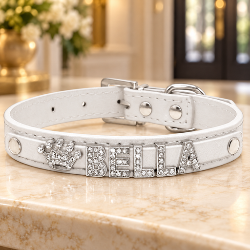 White collar with BELLA crystal letters and crown on an ivory console.