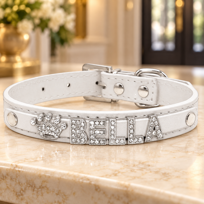 White collar with BELLA crystal letters and crown on an ivory console.