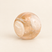 Translucent peach treat ball with a pale circular end cap