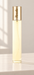 Slender perfume bottle with a gold cap on an ivory surface.