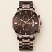 Brown metal chronograph watch on ivory surface