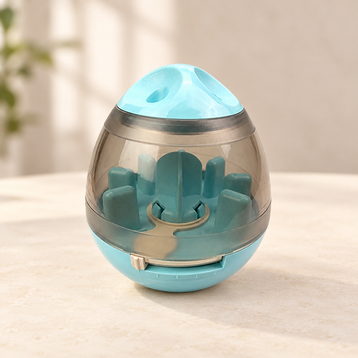 Pale turquoise treat dispenser with clear shell and adjustable front opening