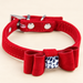 Red bow pet collar with white and navy spotted centre ornament
