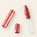 Three components of a rose-coloured perfume atomizer