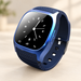 Blue smartwatch with analog display on ivory tabletop