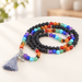 Coiled multicolour and black bead necklace with a grey tassel.