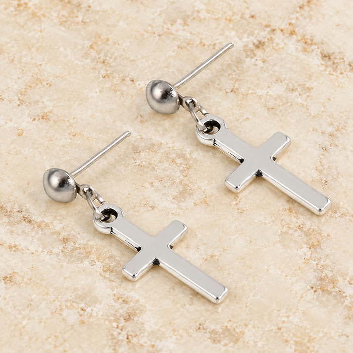 Silver cross drop stud earrings on ivory stone