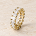 Gold-colour ring with oval clear stones on ivory stone.