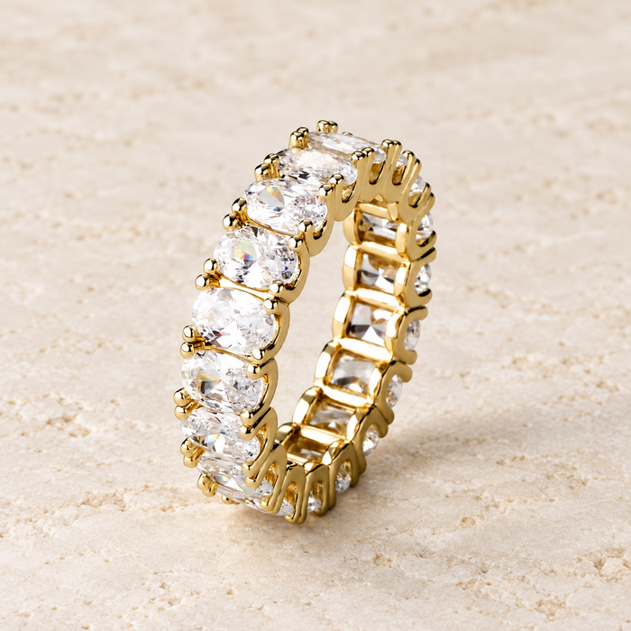 Gold-colour ring with oval clear stones on ivory stone.
