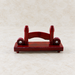 Dark red wooden fan stand on ivory stone.