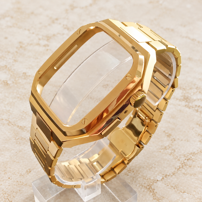 Gold-colour watch case and band set on its transparent display stand.
