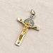 Silver and gold cross pendant on ivory linen.