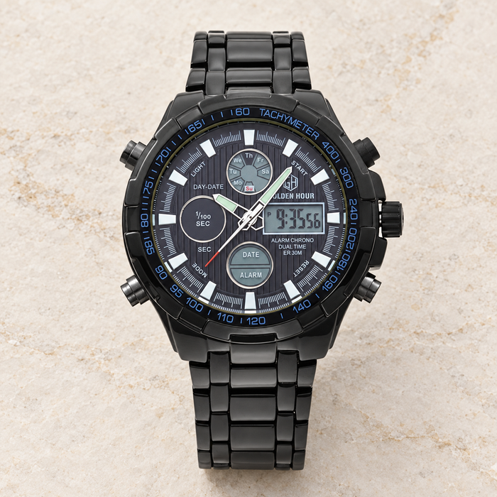 Black metal sports watch on ivory stone.