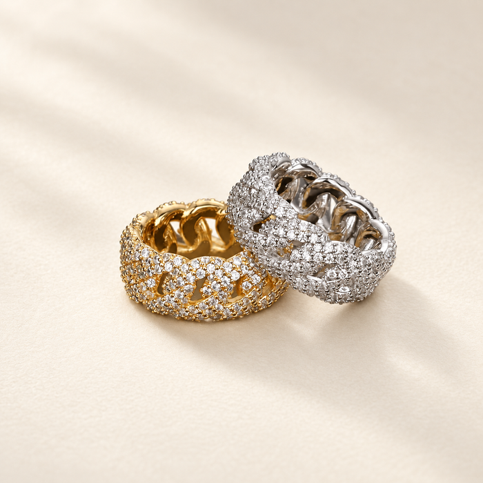 Gold and silver rhinestone link rings on ivory surface