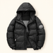 Black hooded puffer coat with front pockets and a round sleeve emblem on an ivory background