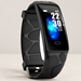 Black fitness watch with blue screen and patterned strap on an ivory surface