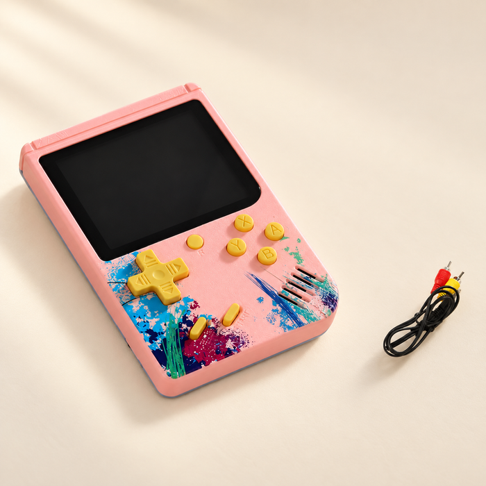 Pink handheld game console with yellow controls and cable