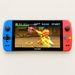 Blue and red PS7000 handheld game console on an ivory surface