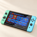 Mint and cyan handheld console displaying game menu