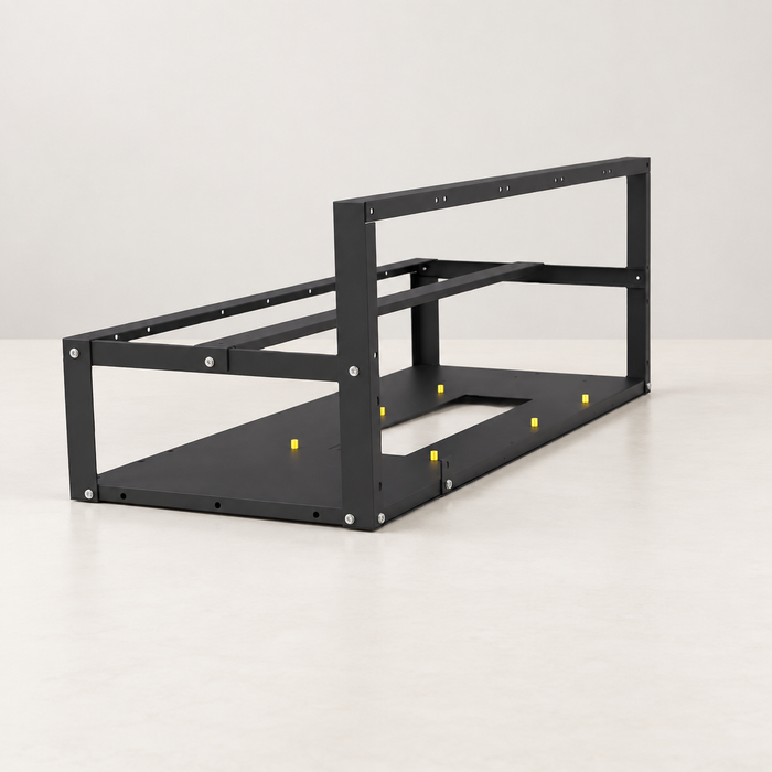 Black open computer chassis frame on an ivory worktable
