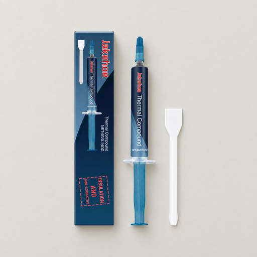 Blue thermal compound syringe with spatula and carton on ivory surface