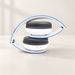 Folded white and blue headphones on an ivory desk.