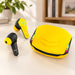Yellow and black gaming earbuds and charging case on an ivory desk.