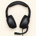 Black over-ear headset with boom microphone on an ivory surface