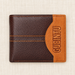 Brown and orange wallet with vertical embossed lettering on ivory linen
