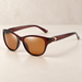 Brown sunglasses with amber lenses and gold temple detail.
