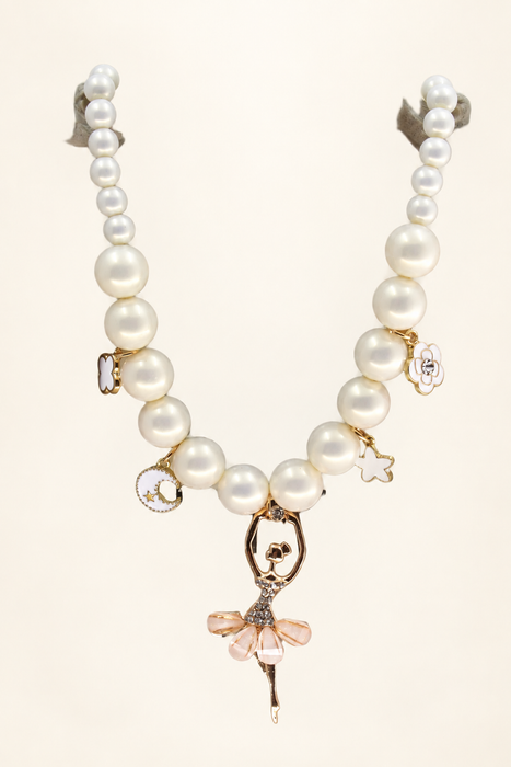 White pearl necklace with enamel charms and a ballerina pendant on two supports