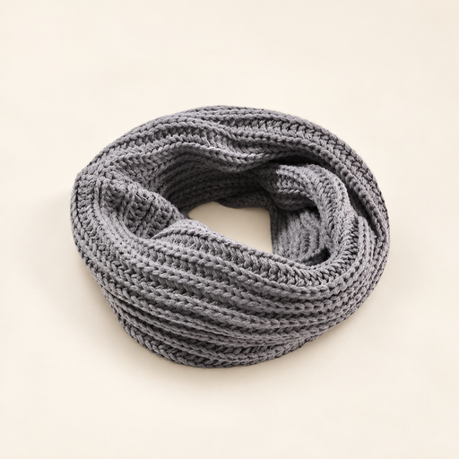 Grey knitted infinity scarf on ivory surface