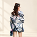 Geometric navy grey and pink scarf draped on model