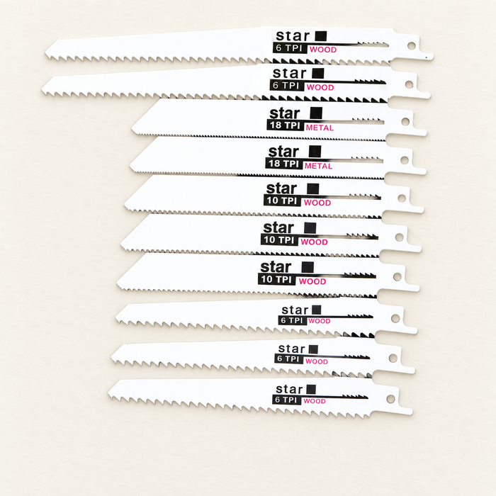 Ten reciprocating saw blades for wood and metal arranged on an ivory surface