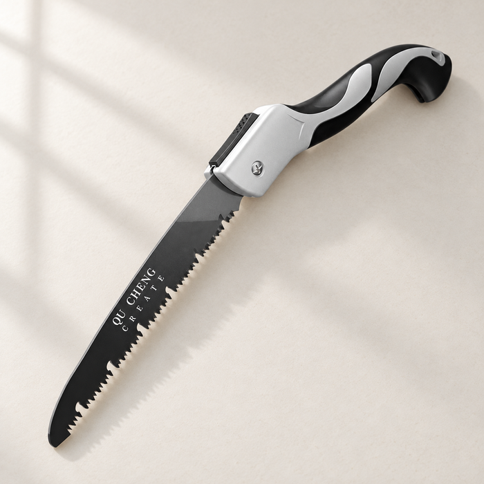 Open folding saw with black blade and silver and black handle on an ivory surface