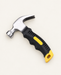 Compact silver claw hammer with a black and yellow grip on an ivory mat.