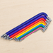 Colour-coded Torx key set arranged diagonally on an ivory workshop surface.