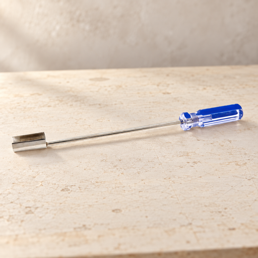 Metal extractor tool with a blue clear handle resting on an ivory workbench.
