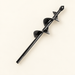Black planting auger drill bit on ivory surface
