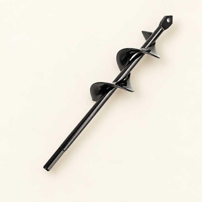 Black planting auger drill bit on ivory surface