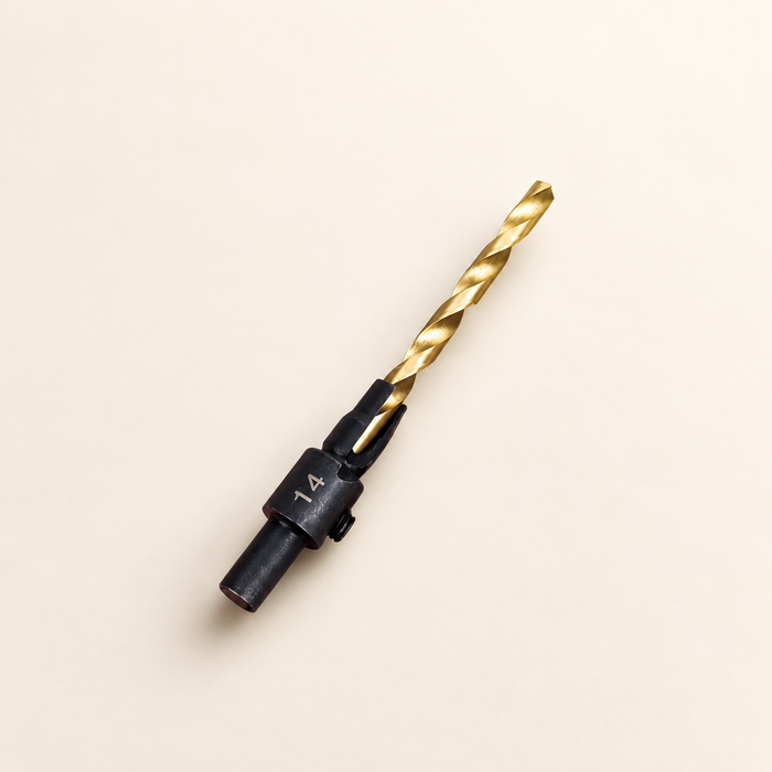Gold and black countersink drill bit marked 14 on ivory