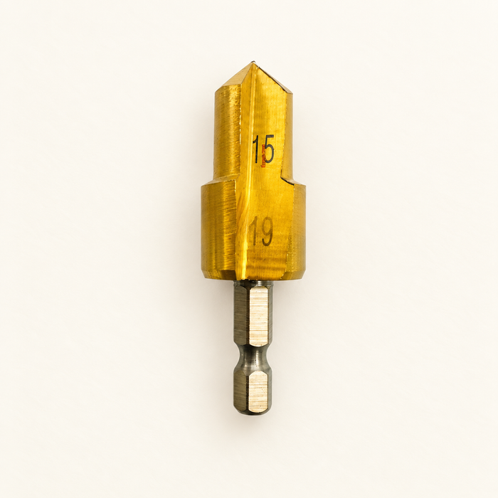 Gold15 and19 two-step reamer bit on ivory surface